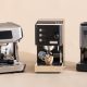 A budget espresso coffee machine beside a fresh cup on a white countertop.